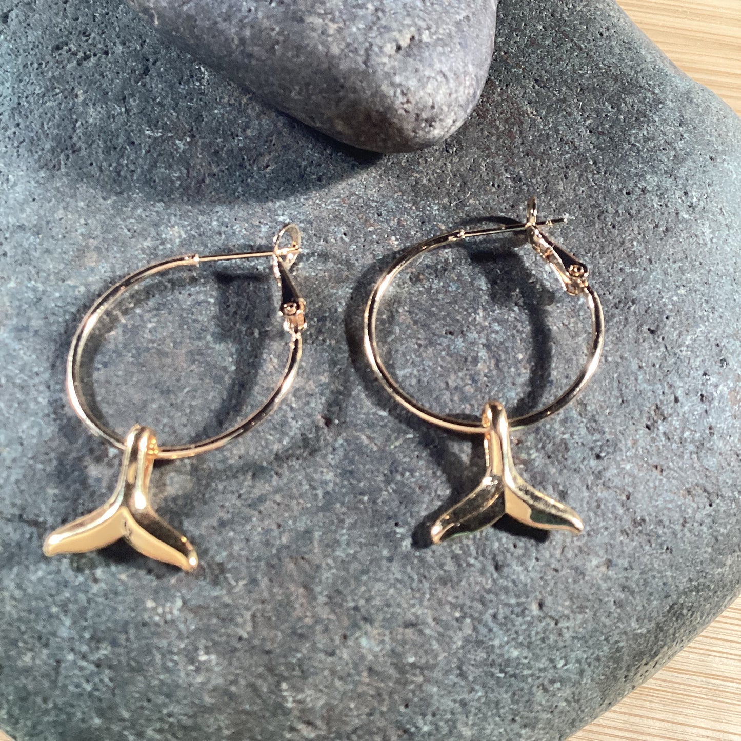 Hoop earrings with gold whale tail charm. 22k gold stainless.