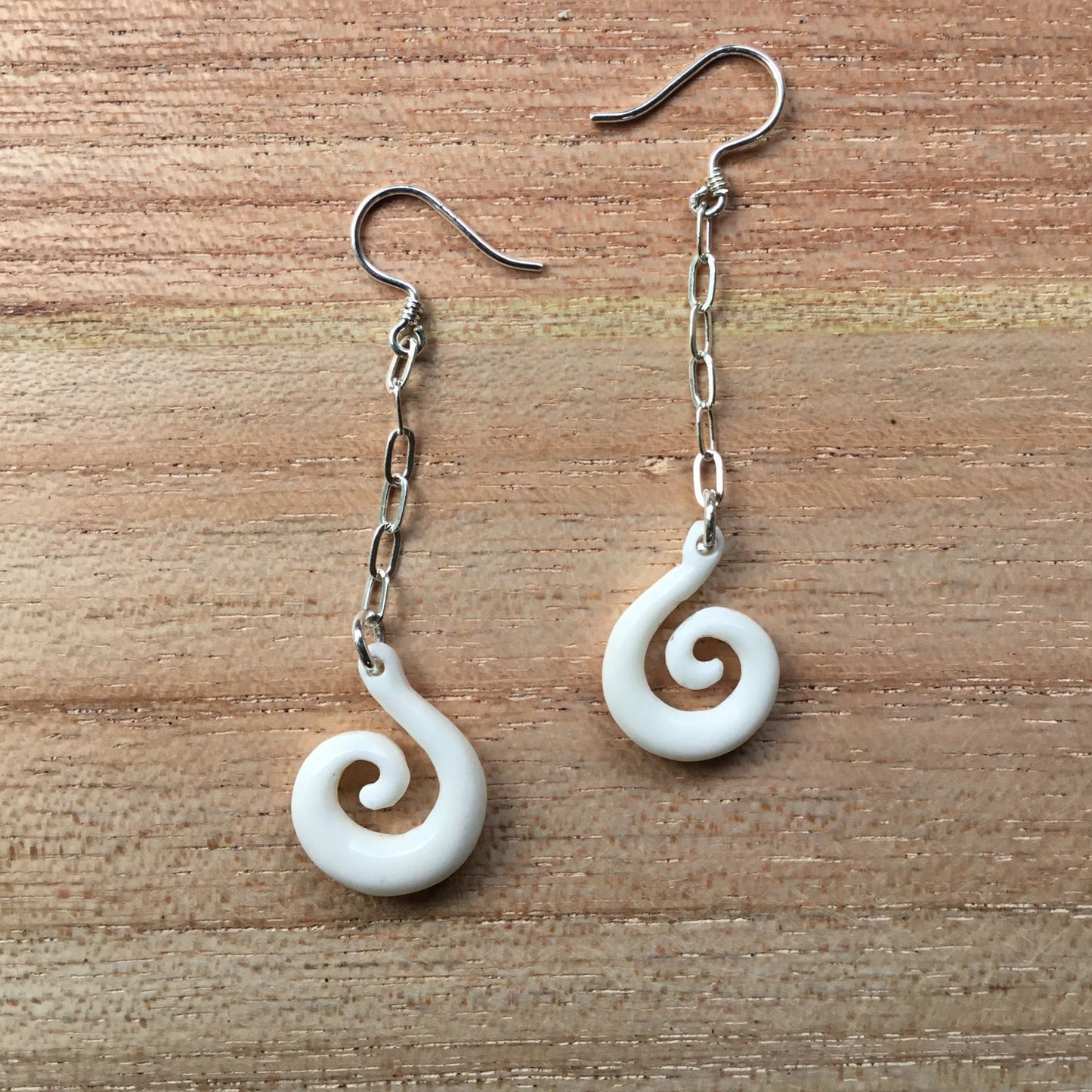 bone and silver earrings, hanging spiral.