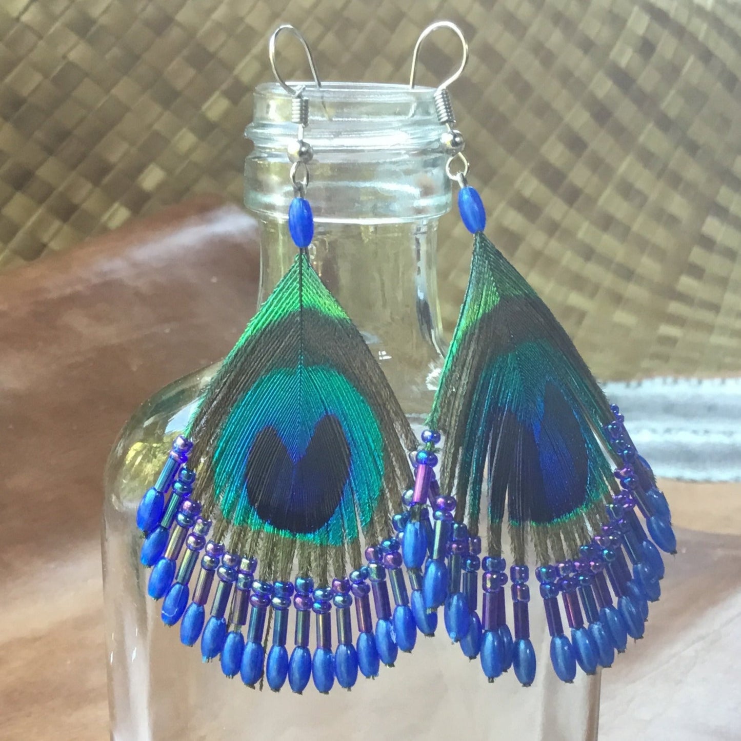 French hook peacock earrings, feather with blue beads.