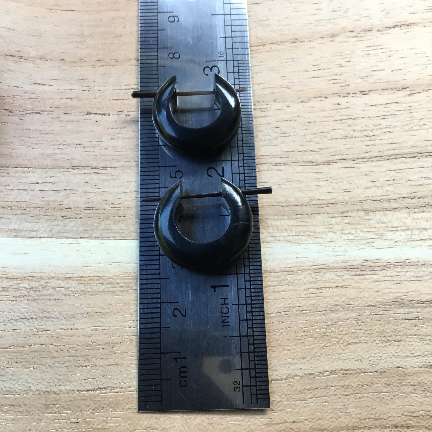Black hoop earrings. Natural. size, 3/4 inch L x 7/8 inch W.