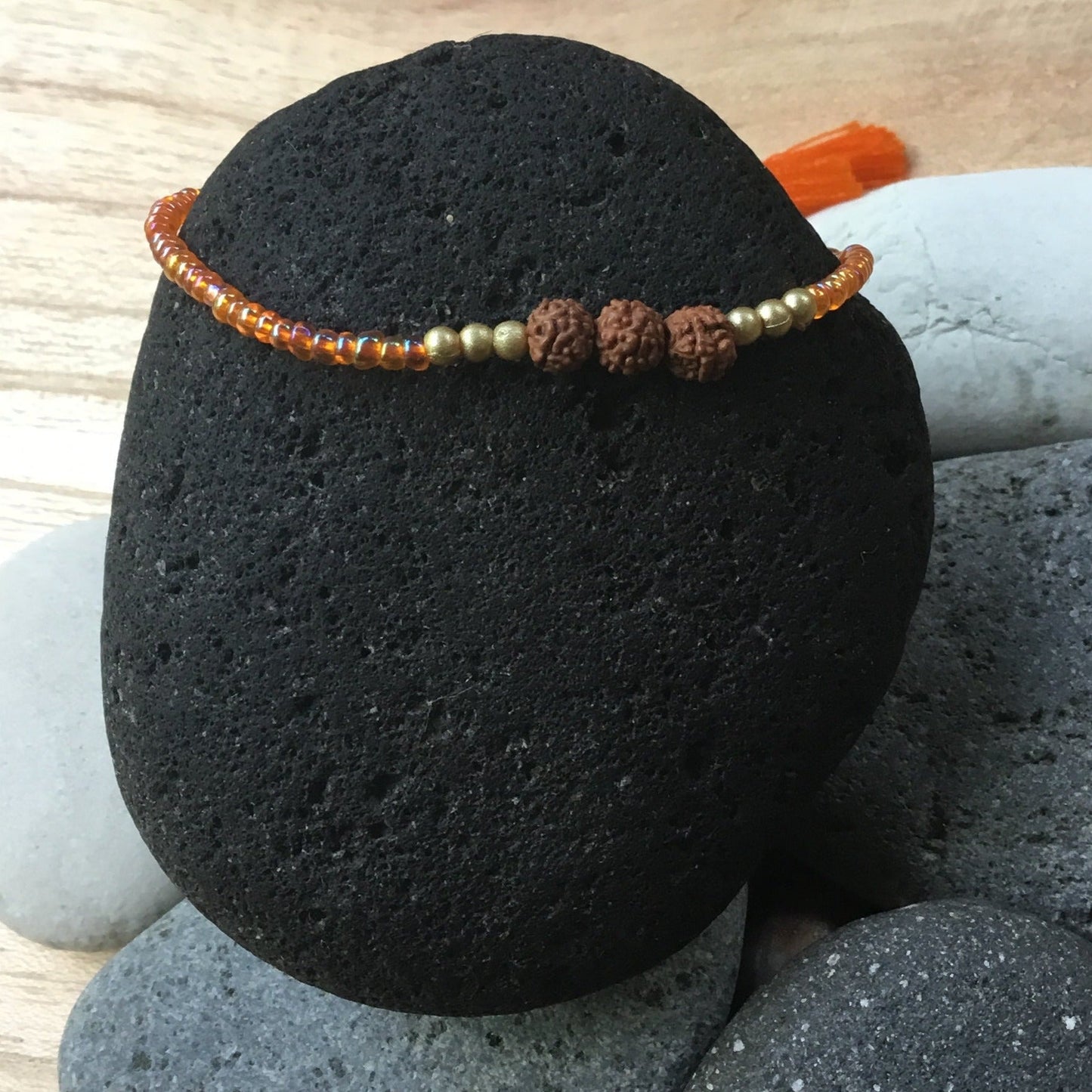 single strand bracelet, orange beads.