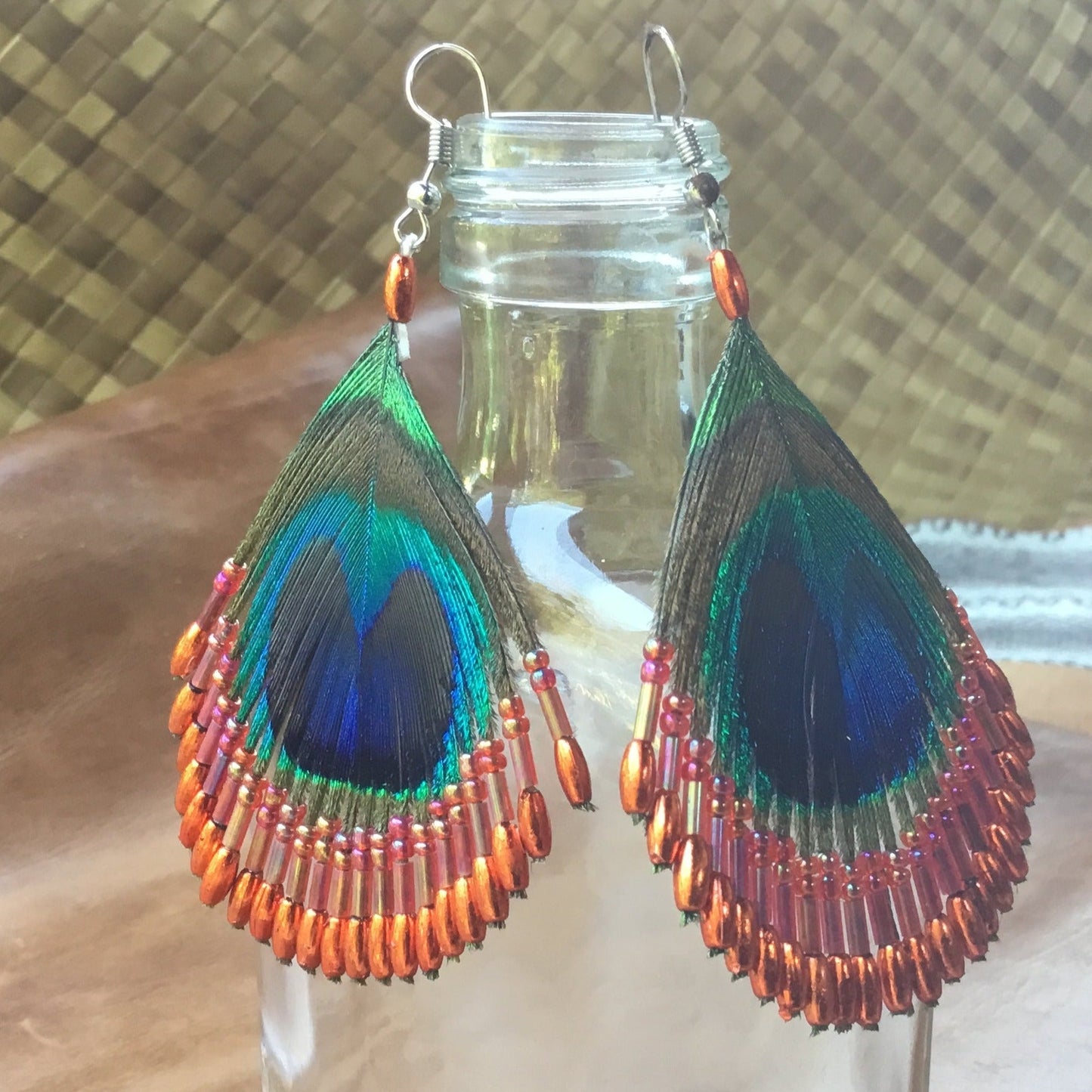 Beaded feather earrings, orange peacock.