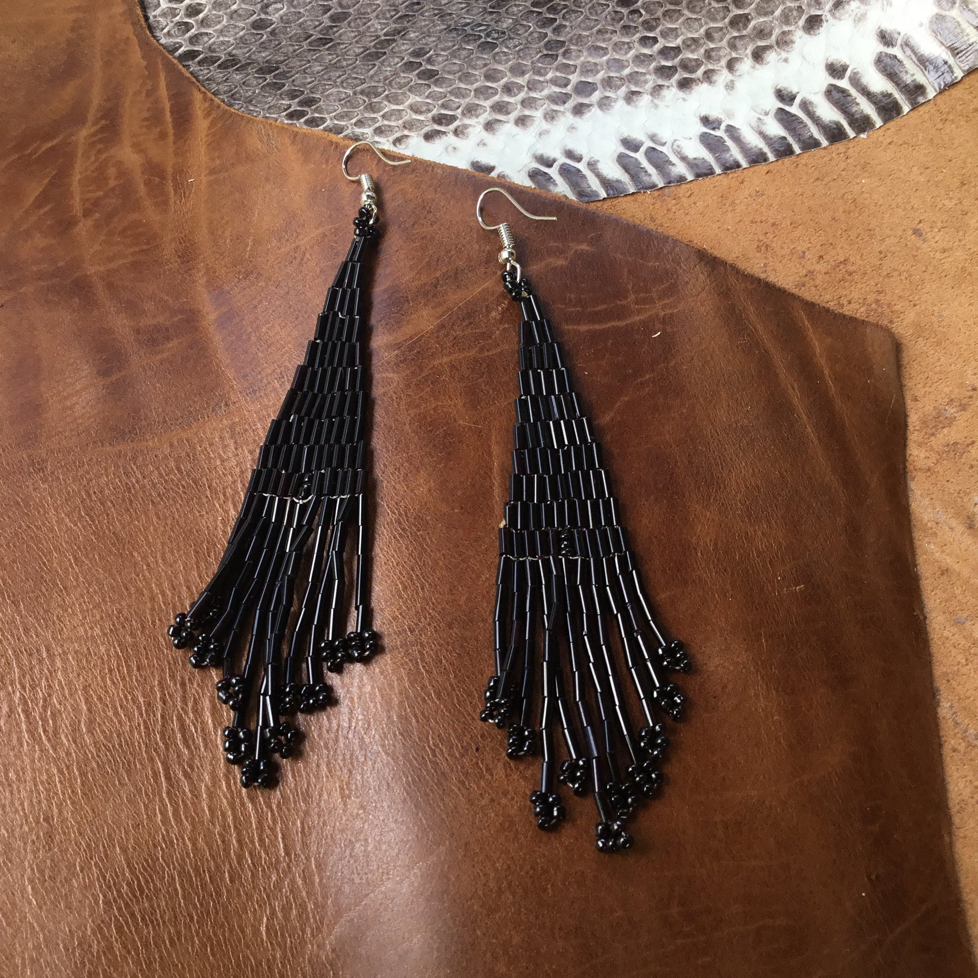 black earrings, long beads.