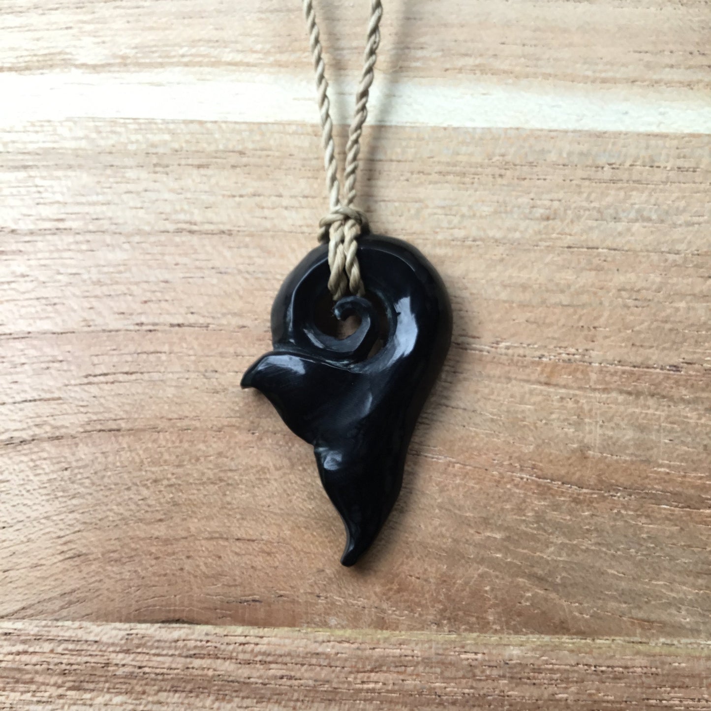 spiral whale tail necklace, black.