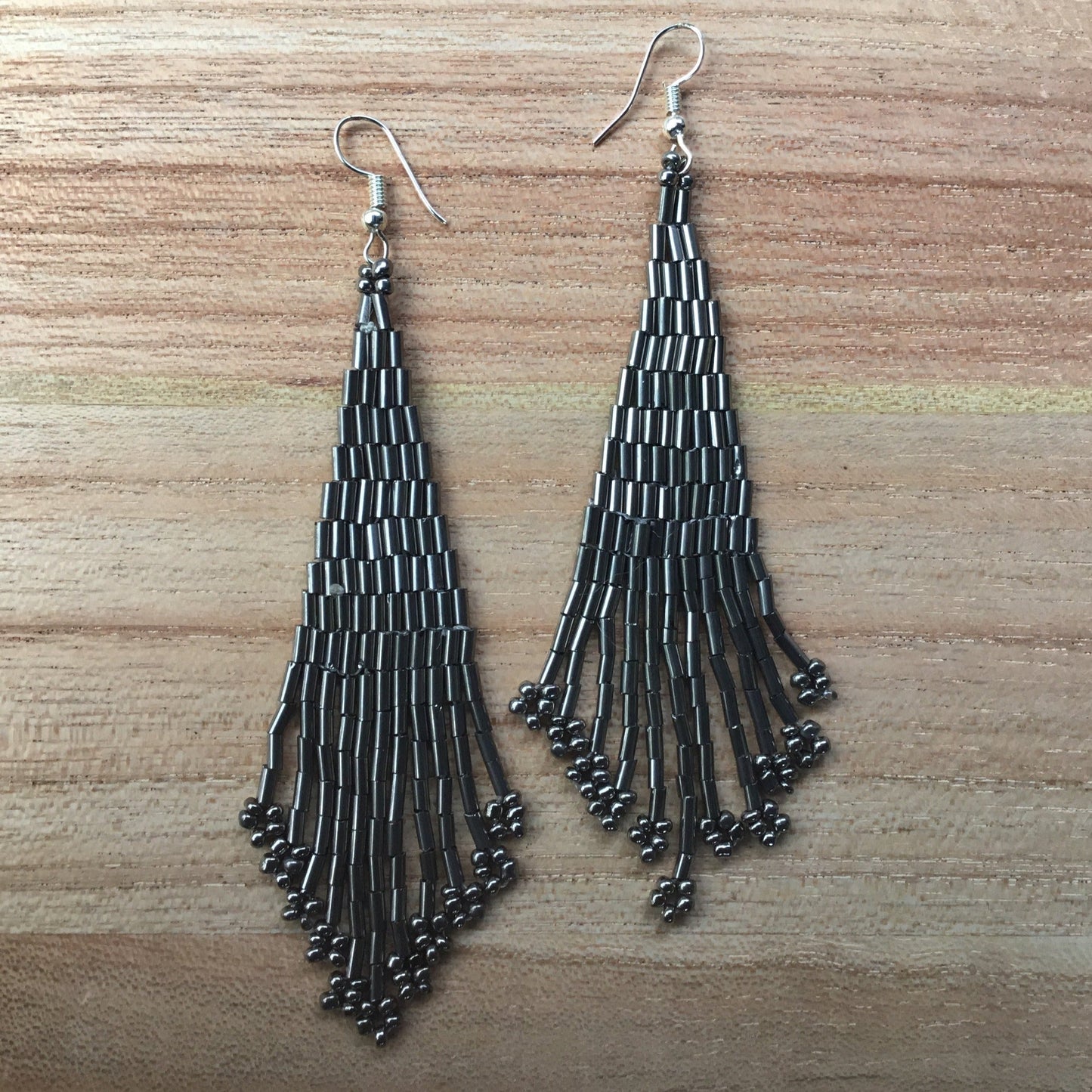 extra long shiny silver beaded earrings.