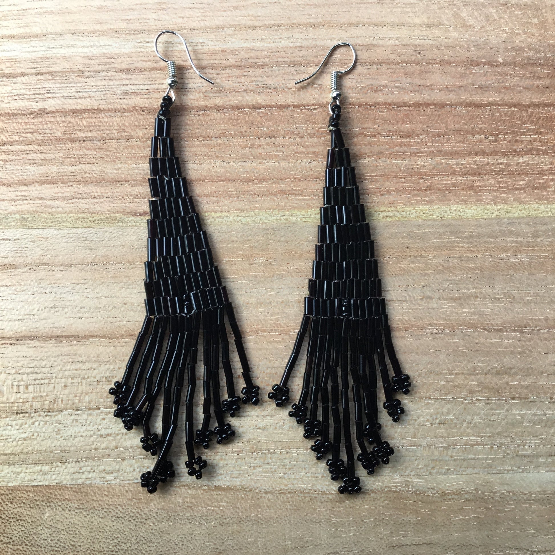 Long black earrings.