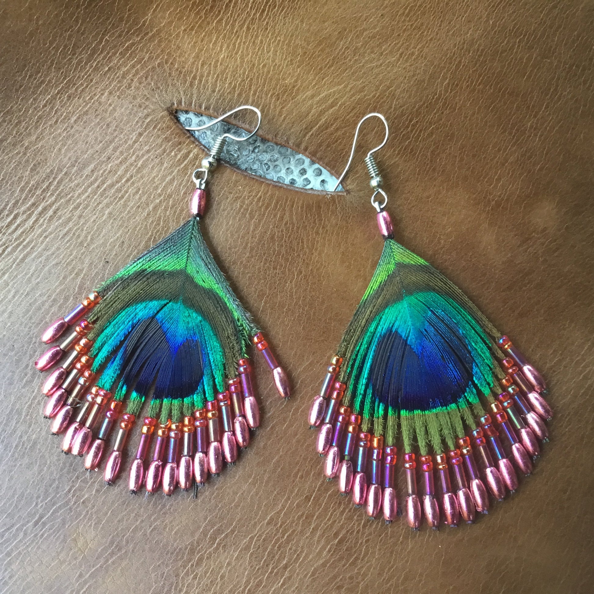 Peacock feather earrings with coral pink metalic beads