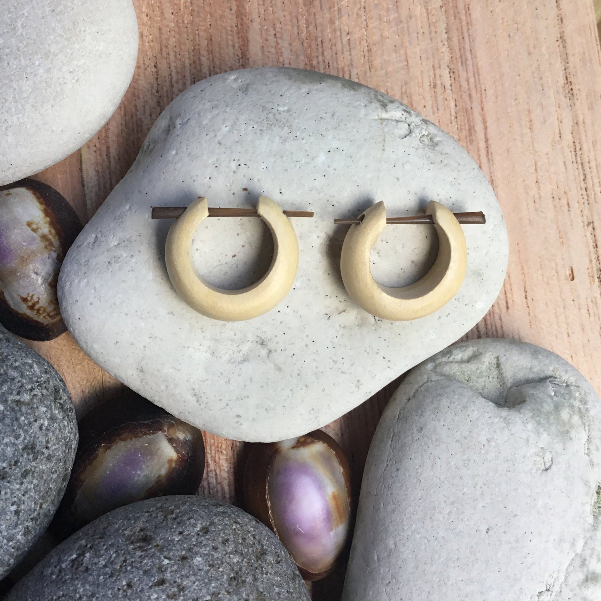 small hoop earrings, wood, light.