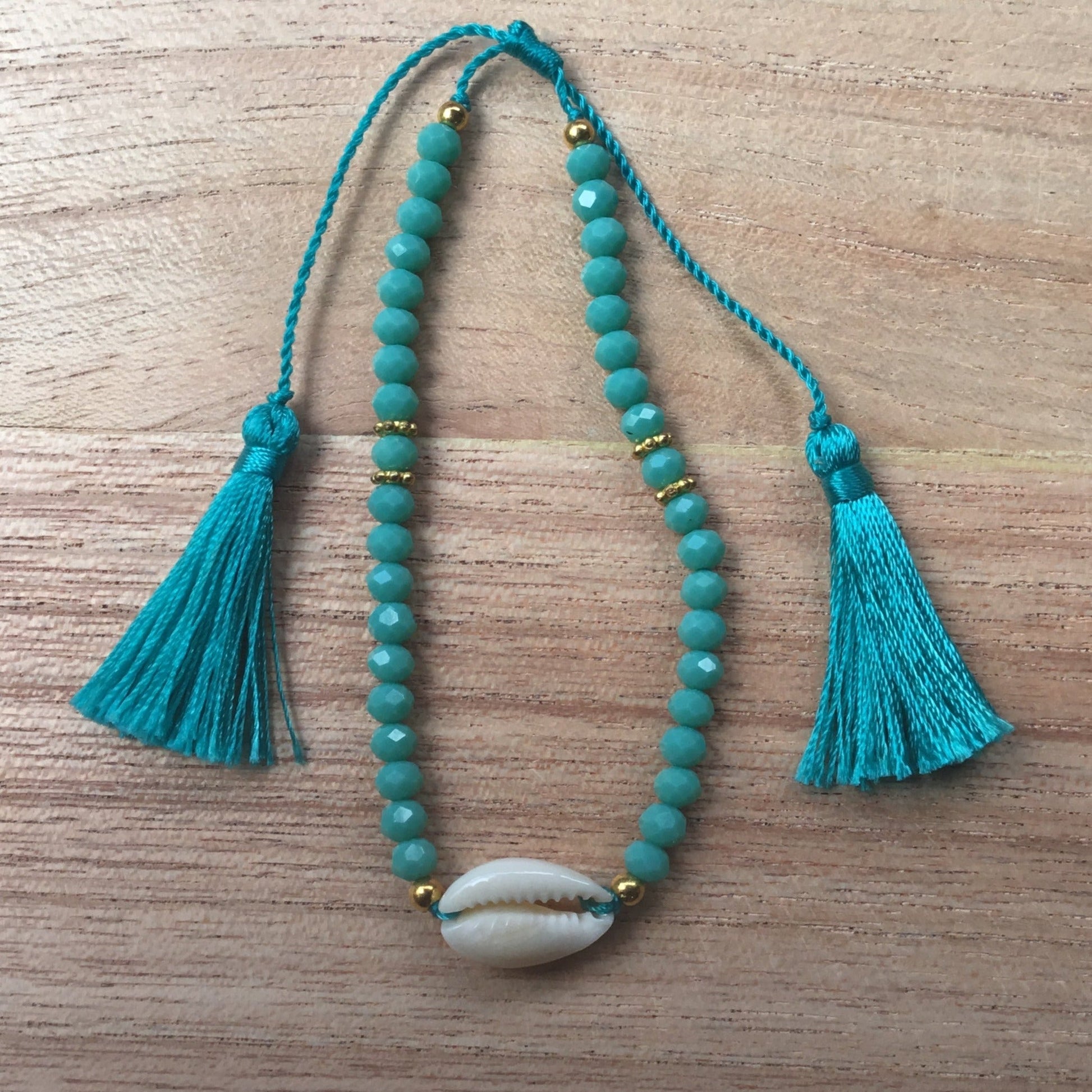 Stackable tassel bracelet, blue, adjustable, with seashell.