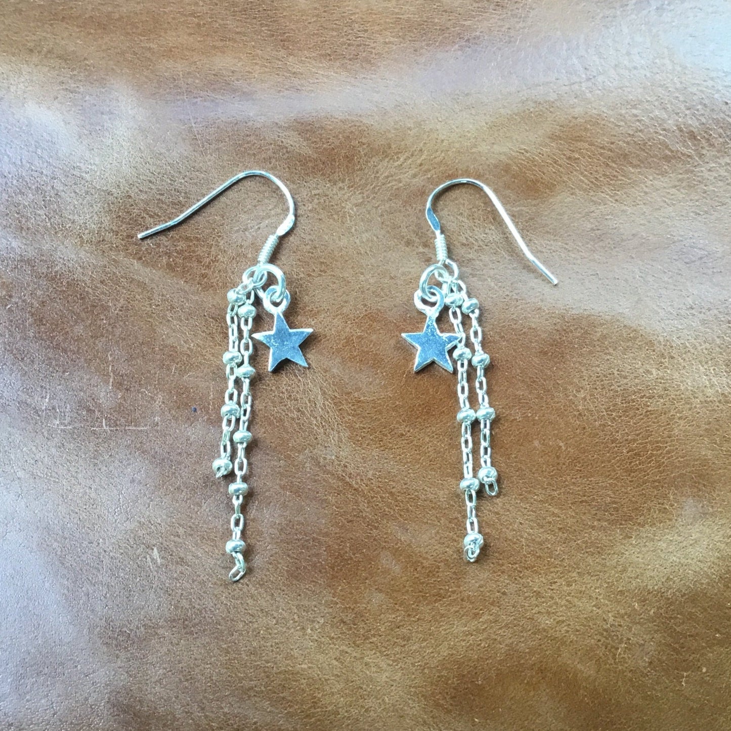 Star dangle earrings, silver hook.
