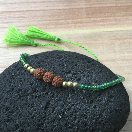Stackable green bead strand bracelet with Rudraksha.